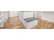 Walk-in closet island with hardwood floors and black countertop at 632 Dorothy Dr, Charlotte, NC 28203