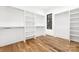 Walk-in closet with hardwood flooring, shelving, and a window at 632 Dorothy Dr, Charlotte, NC 28203