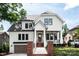Charming two-story home showcasing a white exterior, black trim windows, and a welcoming front porch at 632 Dorothy Dr, Charlotte, NC 28203