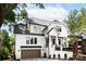 Two-story home with a white exterior, black trim windows, brown garage door, and a welcoming front entrance at 632 Dorothy Dr, Charlotte, NC 28203