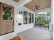 Inviting front porch with stained wood ceiling and black accents, providing a cozy outdoor space at 632 Dorothy Dr, Charlotte, NC 28203