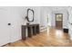 Bright hallway with a console table, modern mirror, and hardwood flooring at 632 Dorothy Dr, Charlotte, NC 28203