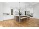 Spacious kitchen with white cabinets, hardwood floors, and a large island with seating at 632 Dorothy Dr, Charlotte, NC 28203