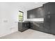 Laundry room with gray cabinets, sink, and decorative floors at 632 Dorothy Dr, Charlotte, NC 28203