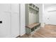Mudroom with coat rack, bench, and wood cubbies at 632 Dorothy Dr, Charlotte, NC 28203