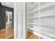 Pantry with white shelving and hardwood flooring at 632 Dorothy Dr, Charlotte, NC 28203