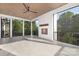 Screened porch with tile flooring, ceiling fan, and fireplace at 632 Dorothy Dr, Charlotte, NC 28203