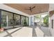 Screened porch featuring sliding glass doors, ceiling fan, and tile flooring at 632 Dorothy Dr, Charlotte, NC 28203