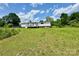 View of the back exterior with a well-maintained deck and a vast backyard under a bright sky at 645 E Border E Rd, Rock Hill, SC 29730