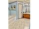 Bathroom features a tub, wooden cabinets, a neutral tile floor, and ample storage at 645 E Border E Rd, Rock Hill, SC 29730
