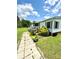 Charming single-story home with a front porch, nestled in a green lawn with flowers and a paved path at 645 E Border E Rd, Rock Hill, SC 29730