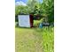 Storage shed with an open extension surrounded by overgrown greenery at 645 E Border E Rd, Rock Hill, SC 29730
