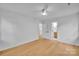 Bright bedroom features modern ceiling fan and light toned wood flooring at 7328 Starvalley Dr, Charlotte, NC 28210