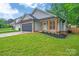 Charming single-story home features a dark garage door and brick accents at 7328 Starvalley Dr, Charlotte, NC 28210