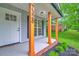 Close up of front porch featuring wood posts and well landscaped flower beds at 7328 Starvalley Dr, Charlotte, NC 28210