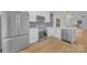 Bright kitchen with stainless steel appliances, white cabinets and modern lighting at 7328 Starvalley Dr, Charlotte, NC 28210