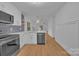 Modern kitchen with white cabinets and stainless steel appliances at 7328 Starvalley Dr, Charlotte, NC 28210