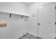 Clean laundry room with patterned floors and door to exterior at 7328 Starvalley Dr, Charlotte, NC 28210