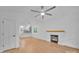 Bright, open living room featuring fireplace, ceiling fan, and view into the kitchen at 7328 Starvalley Dr, Charlotte, NC 28210