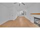 Bright, open living room featuring fireplace, ceiling fan, and view into the kitchen at 7328 Starvalley Dr, Charlotte, NC 28210