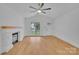 Bright living room featuring fireplace, ceiling fan, and lots of light at 7328 Starvalley Dr, Charlotte, NC 28210