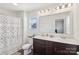 Bright bathroom featuring double sinks, modern fixtures, and a shower-tub combination at 804 Yorkshire Dr, Albemarle, NC 28001