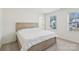 Light-filled bedroom with natural wood bed frame and carpet flooring at 804 Yorkshire Dr, Albemarle, NC 28001