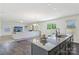 Spacious open kitchen with stainless appliances, eat-in island, and view of the living room at 804 Yorkshire Dr, Albemarle, NC 28001