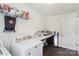 Well-lit laundry room featuring modern appliances and ample counter space for folding and organizing at 804 Yorkshire Dr, Albemarle, NC 28001
