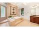 Bright bathroom featuring a soaking tub with tile surround and a glass-block shower at 925 Giacomo Dr, Waxhaw, NC 28173