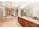 Bright bathroom featuring a double sink vanity with granite counters and tiled walls at 925 Giacomo Dr, Waxhaw, NC 28173