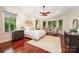 Cozy bedroom with cherry floors, sitting area, and serene views at 925 Giacomo Dr, Waxhaw, NC 28173