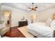 Large bedroom with cherry floors, ceiling fan, and access to ensuite bathroom at 925 Giacomo Dr, Waxhaw, NC 28173