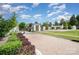 The Gates community entrance featuring white fencing, beautiful landscaping and a brick-paved entry at 925 Giacomo Dr, Waxhaw, NC 28173