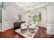 Elegant dining room featuring a coffered ceiling, designer lighting, and white wainscotting at 925 Giacomo Dr, Waxhaw, NC 28173
