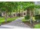 Beautiful estate home with circular driveway and a lushly landscaped yard with mature shade trees at 925 Giacomo Dr, Waxhaw, NC 28173