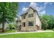 Beautiful brick and stone house featuring an attached three-car garage and well-maintained landscaping at 925 Giacomo Dr, Waxhaw, NC 28173