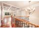 Beautiful foyer with coffered ceilings, hardwood floors, wrought iron railings, and an elegant chandelier at 925 Giacomo Dr, Waxhaw, NC 28173