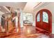 Elegant foyer with a winding staircase, arched doorway, and gleaming hardwood floors at 925 Giacomo Dr, Waxhaw, NC 28173