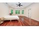 Bright main bedroom features hardwood floors, a tray ceiling, and three large windows at 925 Giacomo Dr, Waxhaw, NC 28173