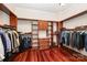 Spacious walk-in closet with custom wood shelving and cabinetry for organization and storage at 925 Giacomo Dr, Waxhaw, NC 28173