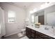 Clean bathroom with a double sink vanity, dark cabinets, and a large mirror at 990 Nw Capwalk Nw Rd # 138, Concord, NC 28027