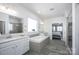 Bright bathroom featuring double vanity, soaking tub with tiled surround, and glass shower at 990 Nw Capwalk Nw Rd # 138, Concord, NC 28027