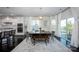 Dining space featuring a dark wood table, modern chairs, bench, and large windows with sheer curtains at 990 Nw Capwalk Nw Rd # 138, Concord, NC 28027