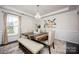 Bright dining area featuring a wood table, upholstered chairs, elegant lighting and modern art at 990 Nw Capwalk Nw Rd # 138, Concord, NC 28027