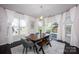 Dining space with a dark wood table, modern chairs, a bench, and large windows with sheer curtains at 990 Nw Capwalk Nw Rd # 138, Concord, NC 28027
