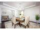Bright dining area with wood table, upholstered chairs, elegant lighting, and modern accents at 990 Nw Capwalk Nw Rd # 138, Concord, NC 28027