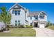 Inviting two-story home featuring stone accents, a well-manicured lawn, and a welcoming entrance at 990 Nw Capwalk Nw Rd # 138, Concord, NC 28027