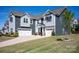 Charming home with a three-car garage, stone accents, manicured lawn, and mature landscaping at 990 Nw Capwalk Nw Rd # 138, Concord, NC 28027