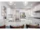 Bright kitchen featuring white cabinetry, granite countertops, stainless appliances, and a large island at 990 Nw Capwalk Nw Rd # 138, Concord, NC 28027